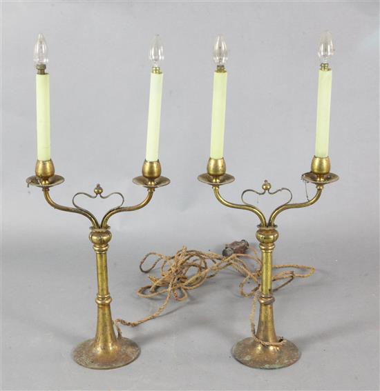 A pair of early 20th century gilt brass twin-branch table lamps Height to fittings 20in.